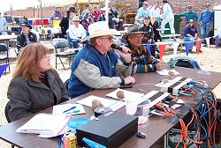 Announcer Jay Faughn (center) with scorekeepers